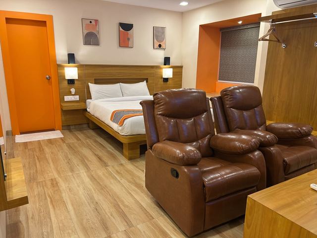 Twin leather recliners facing the bed in the private theatre room