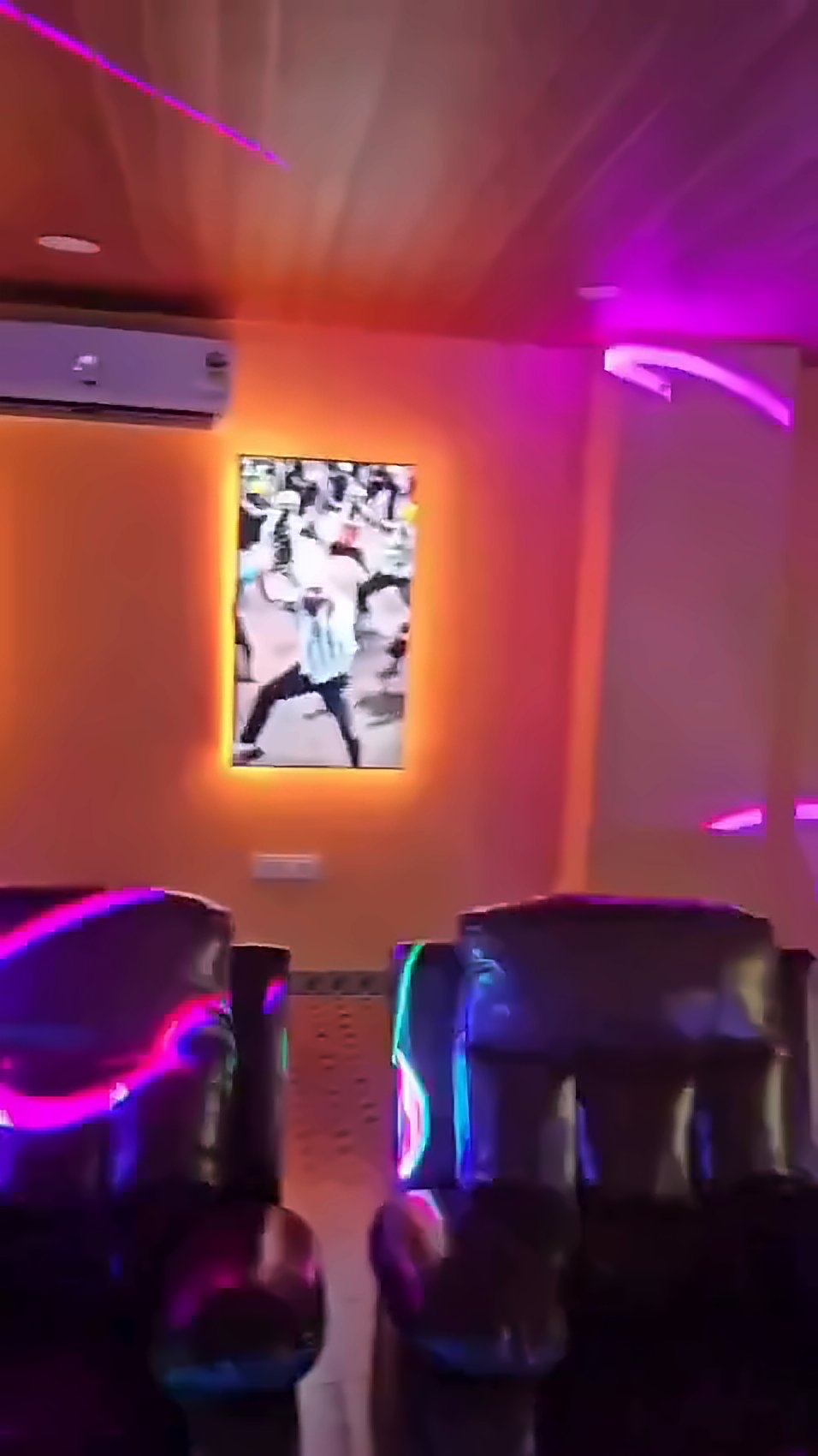 Leather recliners with pink neon lighting in the party hall
