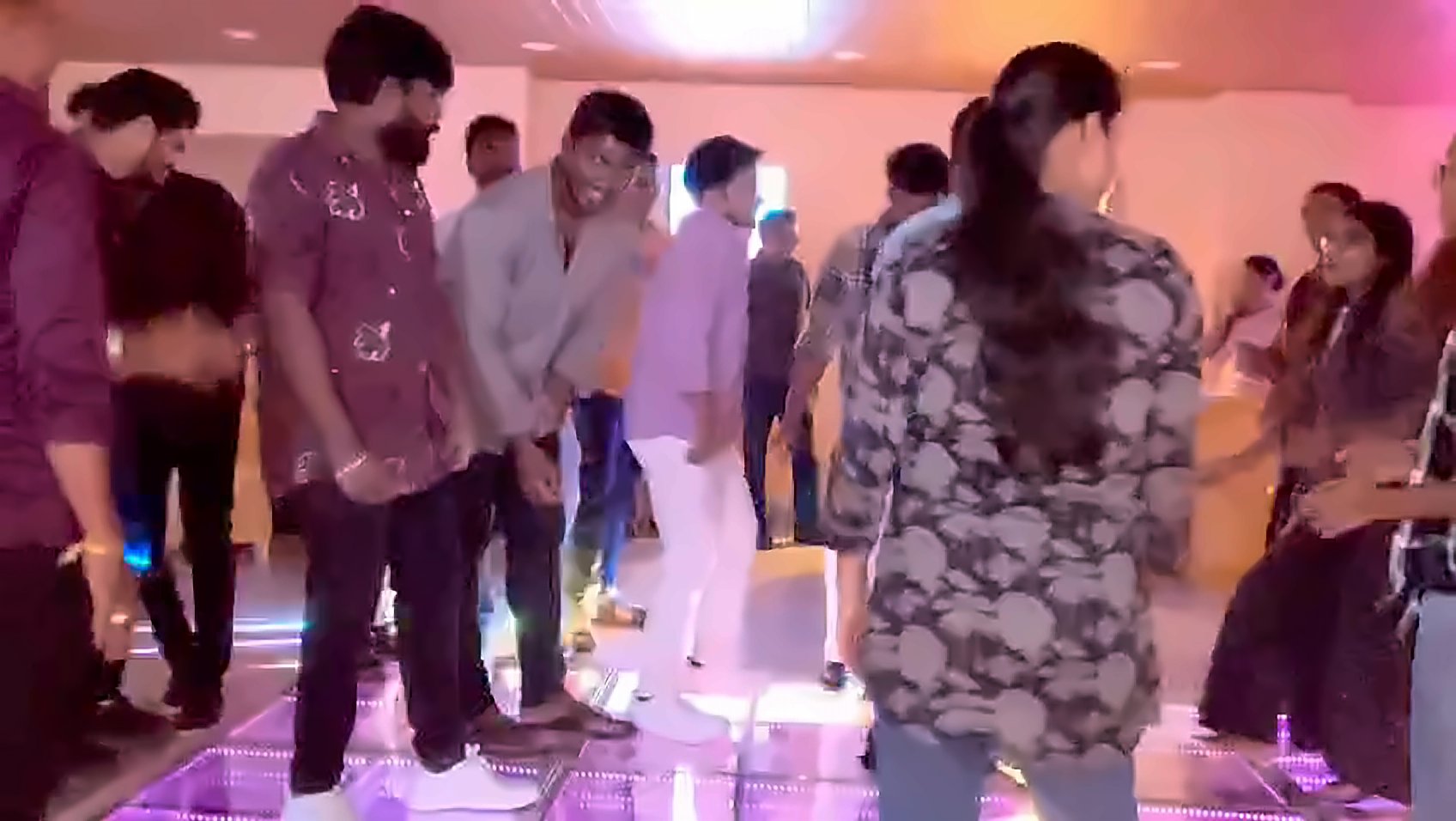 Big group dancing on the glowing LED floor