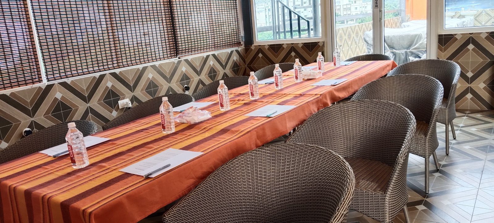 Top-floor hall with a long table set up beside the open terrace doors