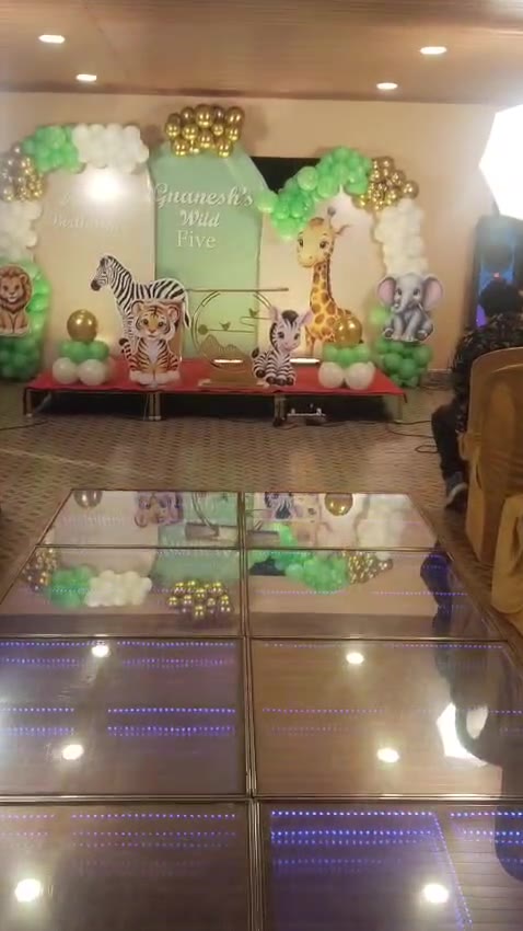 Play video: a jungle-theme kids’ birthday set up in the hall, with a glowing LED aisle